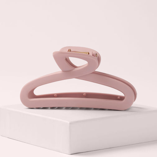 The Hair Edit Flexi Soft Claw Clip on a pink box with a light pink background