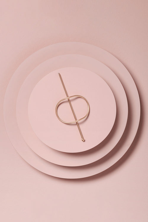 the hair edit hoop and pin gold on a pink background
