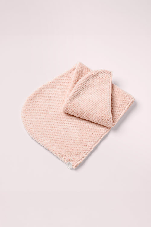 The Hair Edit Smooth & Dry Microfiber Hair Wrap on a pink background 