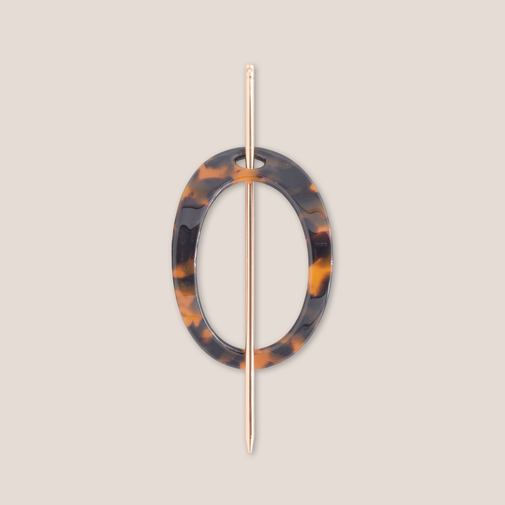 The Hair Edit Editorial Hoop & Pin Tortoise Barrette on a beige background