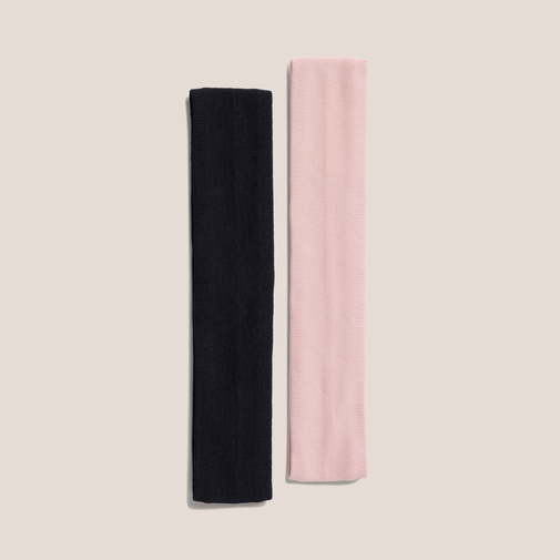 Two fabric headbands, one black and one light pink, displayed side-by-side on a light beige background.