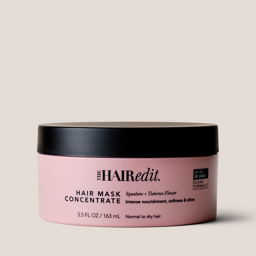 The Hair Edit Hair Mask Concentrate in a light pink jar with a black lid, set against a solid light beige background.