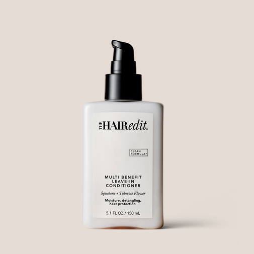 The Hair Edit Multi Benefit Leave-In Conditioner in a 5.1 fl oz white bottle with a black pump dispenser, set against a solid beige background.