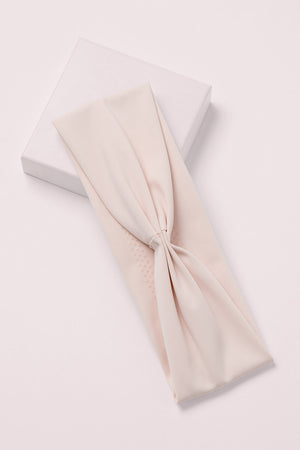 Lotus Soft Pleated Headband on a pink box 