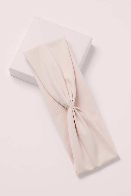 Lotus Soft Pleated Headband on a pink box 