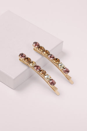 Glow On & Sparkle Gemstone Bobby Pins on a pink box 