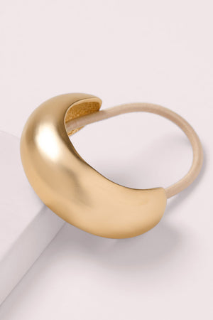 The Hair Edit Brilliant Cuff Arched Gold Metal Hair Tie on a pink box 