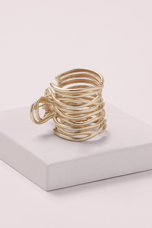 Gilded Wrap Cuff Claw Clip on a pink box 
