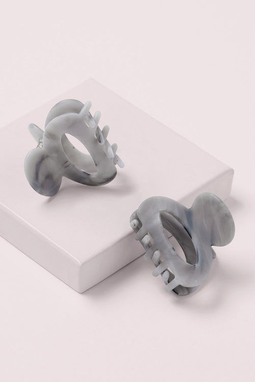 Petite Marble Claw Clips on a pink box 