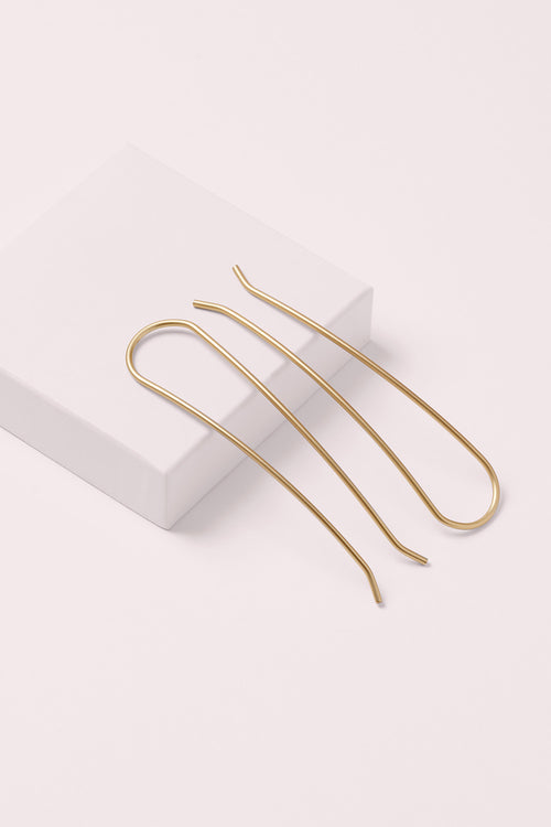 gold slim chignon French hair pin set on a white box 