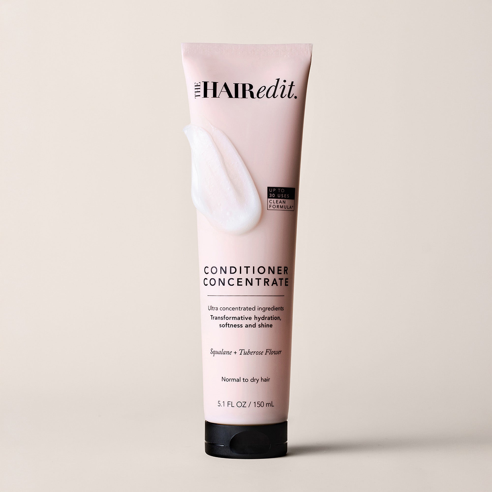 A 5.1 fl oz squeeze tube of The Hair Edit Conditioner Concentrate, shown on a light beige background.11