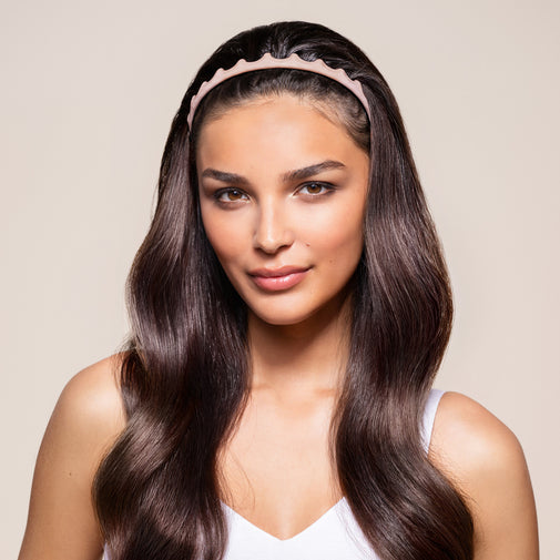 A woman wearing the 90's Icon Flexible Zig Zag Headband in pink