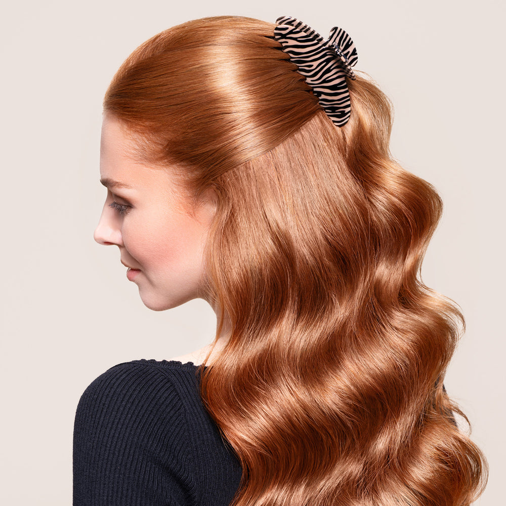 A woman wearing the Untamed Claw Clip in a half up half down hairstyle3