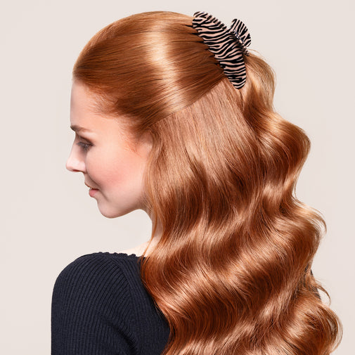 A woman wearing the Untamed Claw Clip in a half up half down hairstyle