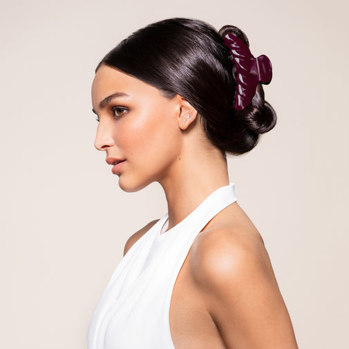 A woman wearing the Bordeaux Claw Clip in a French Twist