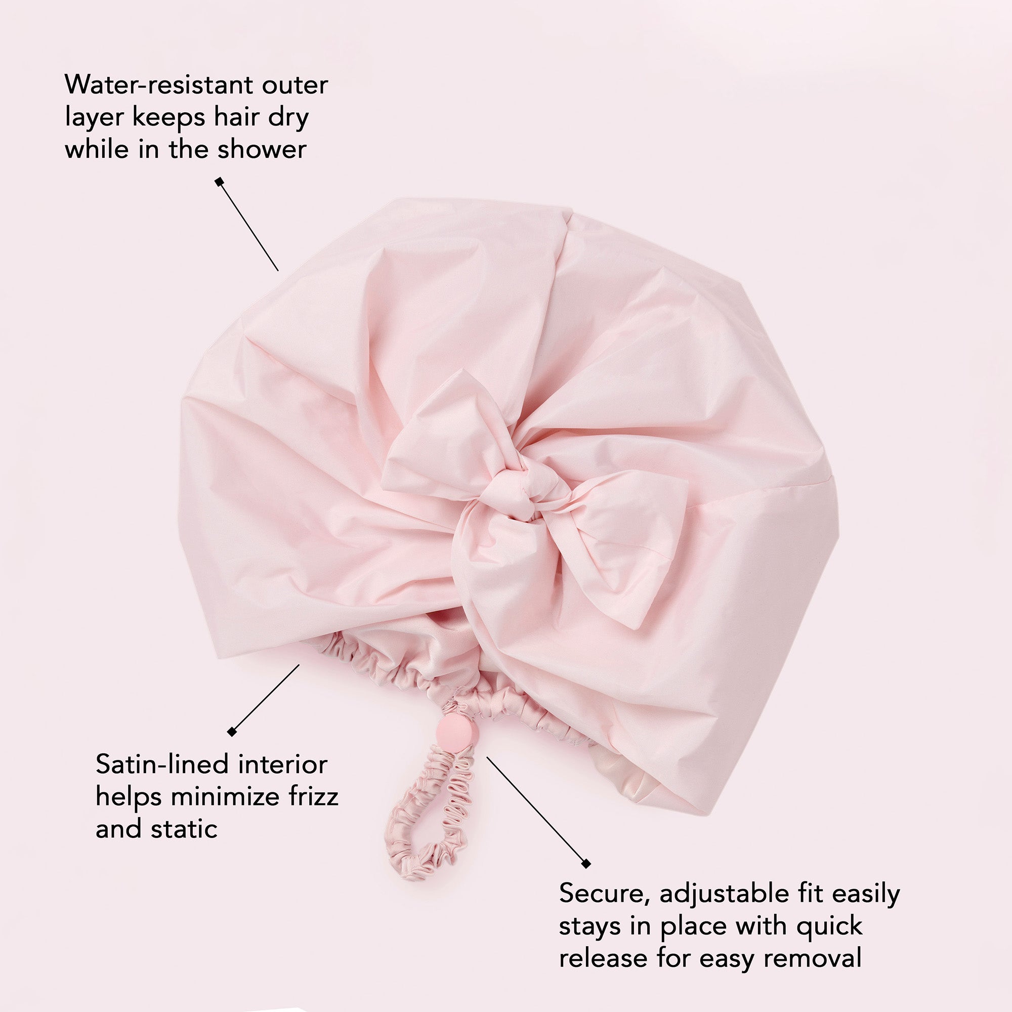A light pink shower cap cover with text callouts explaining its water-resistant outer layer, satin-lined interior, and adjustable elastic closure on a pale pink background.4