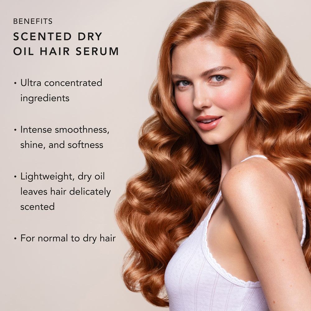 A woman with long, wavy, glossy copper red hair shown in profile against a light beige background, with text on the left reading 'BENEFITS' and 'SCENTED DRY OIL HAIR SERUM' plus bullet points about intense smoothness, shine, softness, and lightweight dry oil leaves.3