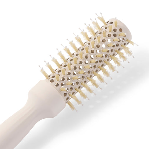 A close-up of a round hairbrush with a cream-colored handle and bristles, set against a clean white background.