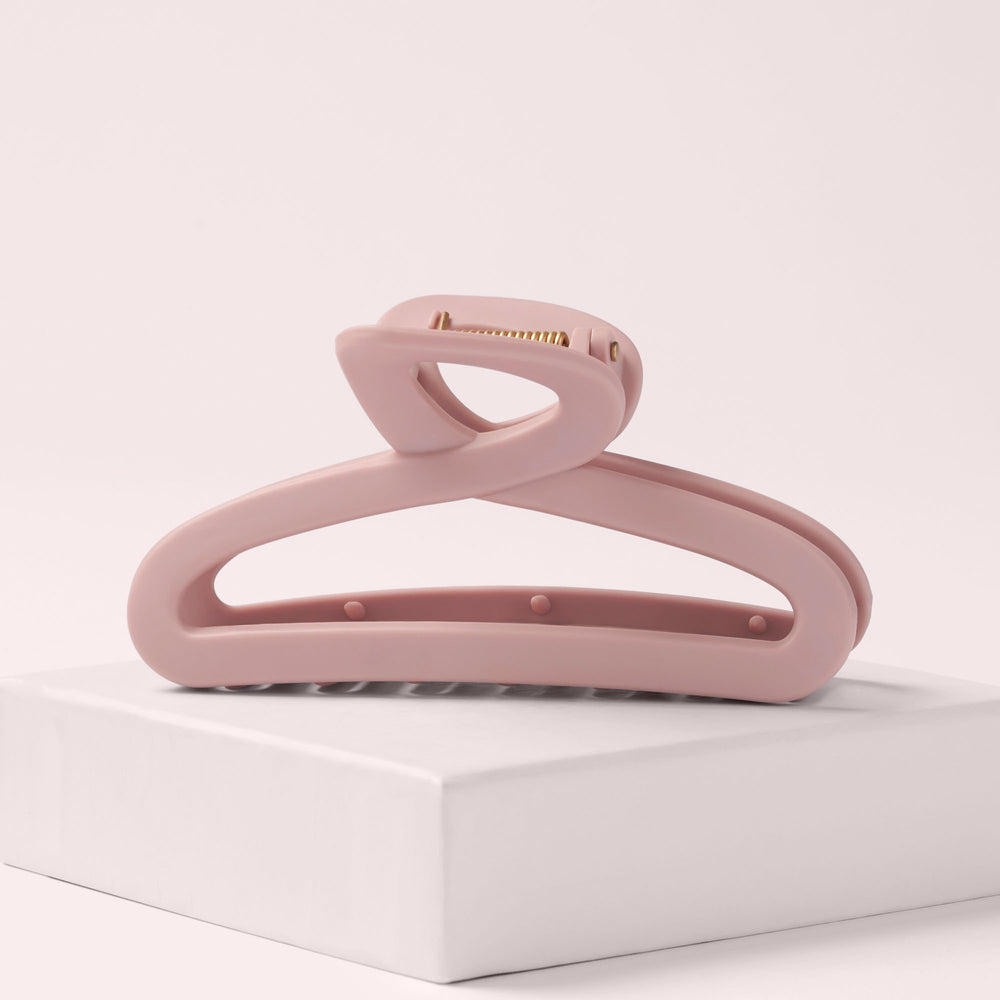 The Hair Edit Flexi Soft Claw Clip on a pink box with a light pink background4