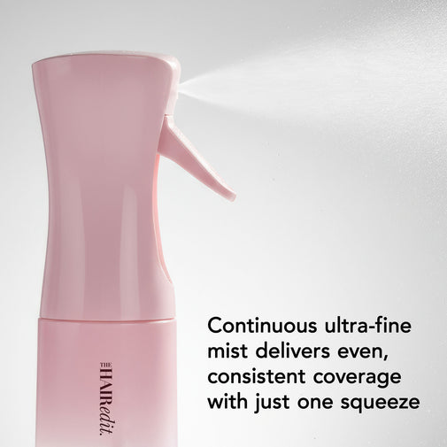 A pink spray bottle with a trigger sprayer emitting a fine mist, shown against a light gray background with descriptive text about continuous ultra-fine mist coverage.