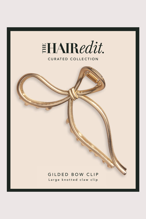 The Hair Edit Gold Gilded Bow Claw Clip in packaging