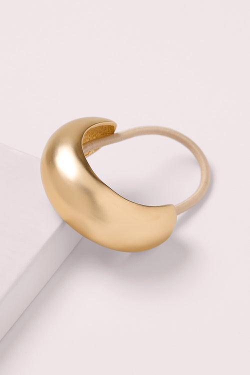 The Hair Edit Brilliant Cuff Arched Gold Metal Hair Tie on a pink box 