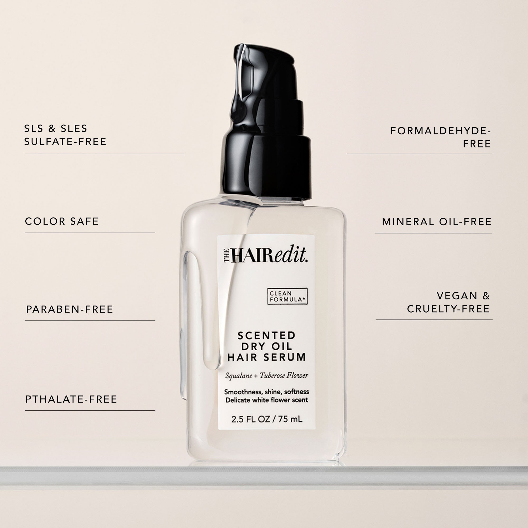 The Hair Edit Scented Dry Oil Hair Serum in a clear bottle with a black pump, centered on a light beige background with feature callouts around it.7