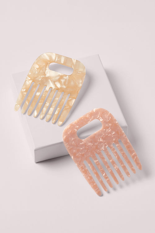 The Hair Edit Untangle & Glide 2 marble cooling & detangling mini combs on a pink box