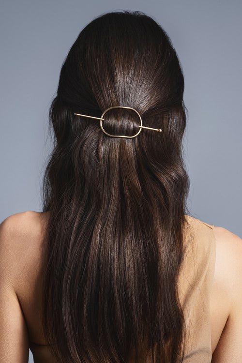brunette model with hoop and pin barrette in hair 
