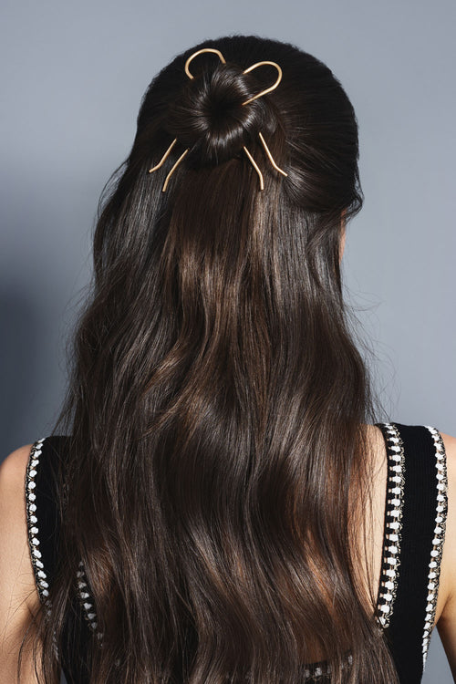 gold slim chignon French hair pin set in models hair bun