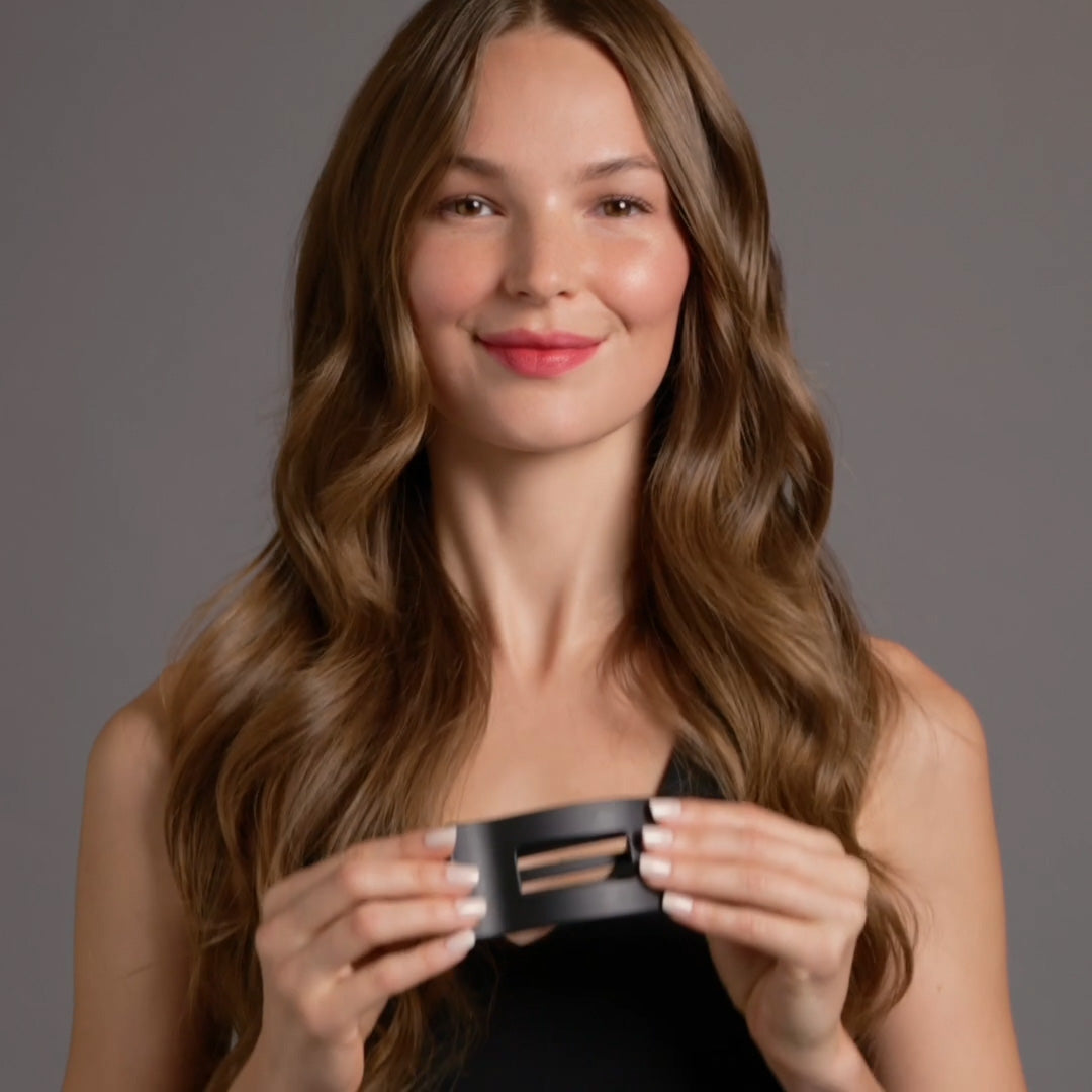 A video of a woman demonstrating how to wear The Hair Edit Flexi Soft Flat Lay Claw Clip  in hair 2