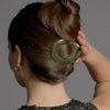Video of model demonstrating how to wear The Hair Edit's Gilded Ellipse Flat Lay Claw Clip