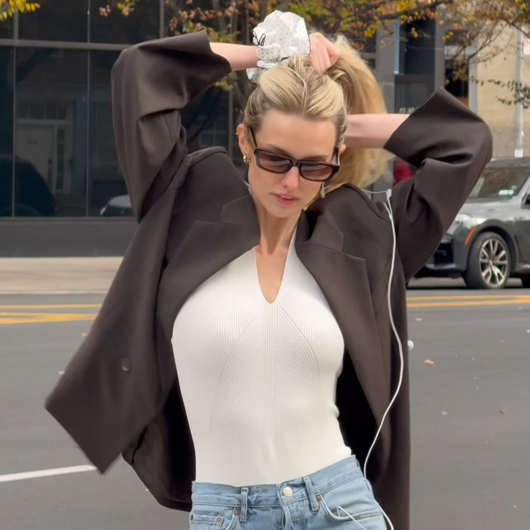 Video of model putting The Hair Edit's Oversized Polka Dot Ruffle Scrunchie in her hair while walking in streets of New York City5