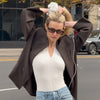 Video of model putting The Hair Edit's Oversized Polka Dot Ruffle Scrunchie in her hair while walking in streets of New York City