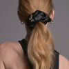 Video of model demonstrating how to wear The Hair Edit's Charming Ruched Ribbons Scrunchie