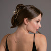 Video of model demonstrating how to wear The Hair Edit's Gilded Festive Bow Claw Clip