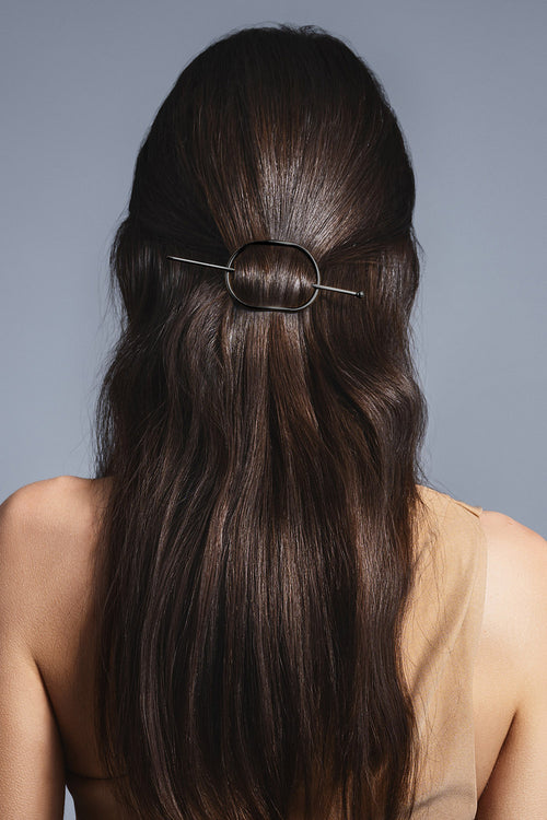 brunette model with a half up hair style using the hair edit's gunmetal hoop and pin barrette 