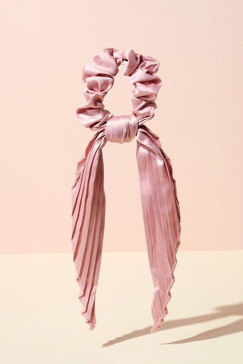 The Hair Edit blush pink pleated ribbon scrunchie hair bow accessory on display