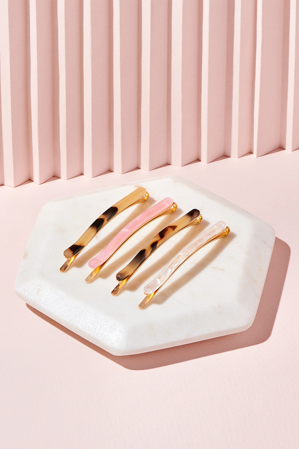 The Hair Edit slim multicolored marble bobby pin set in pink, white & beige/brown on pink display