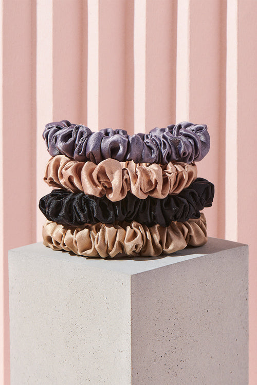 The Hair Edit Multicolor Skinny Ponytail Ruched Ribbon Satin Finish Scrunchies in Set of 4 Hair Accessories in Blush Pink, Light Purple, Beige/Tan & Black Colors on Pink Display