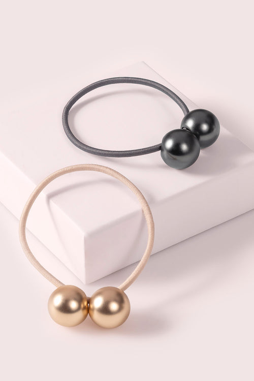The Hair Edit Orb Duo Ponytail Holder Dual-Sphere Metal Hair Tie Accessory in soft gold & black