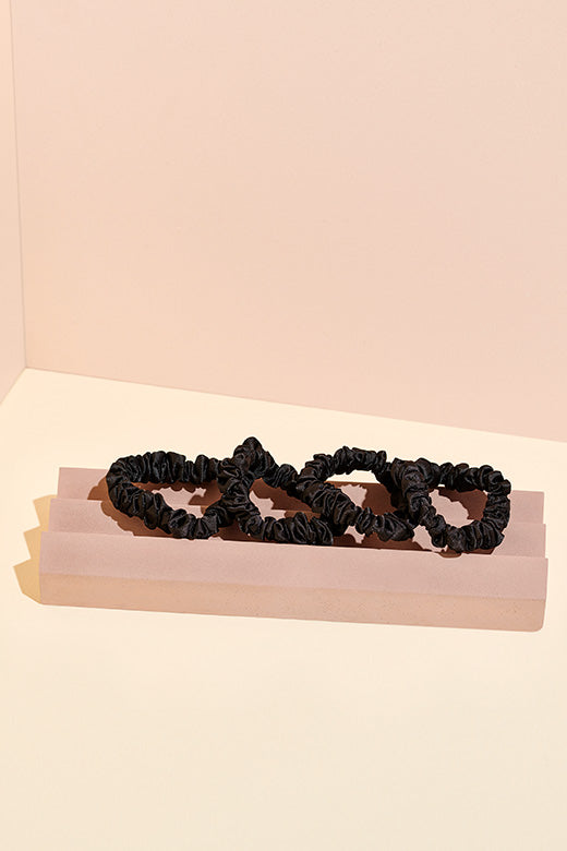The Hair Edit skinny black ruched satin ribbon hair scrunchie accessories in set of 4 on display