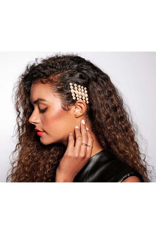 The Hair Edit pearl gold aureate hair pin accessory worn by female model with curly brunette hair