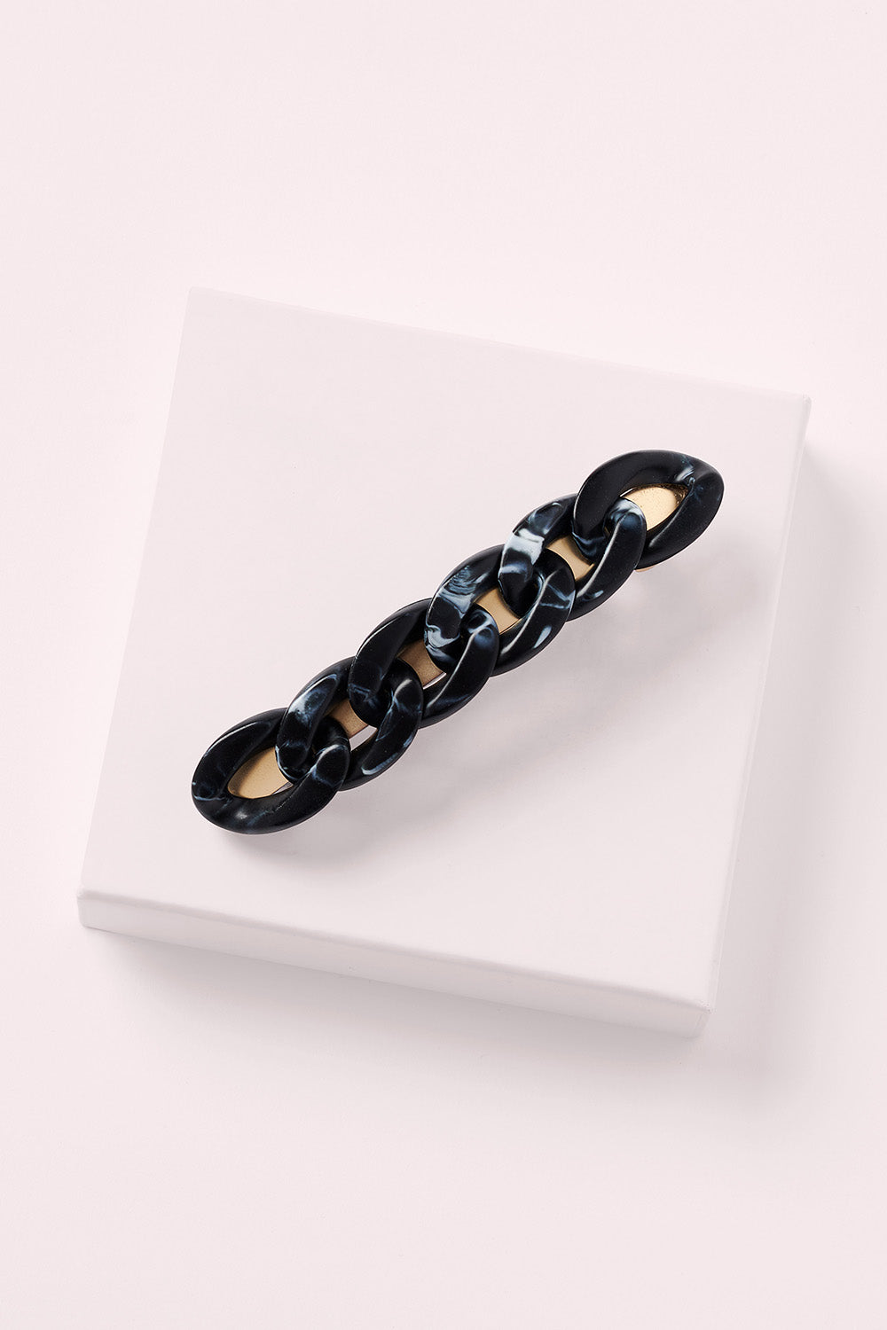 cable baguette barrette in black marble on white box
