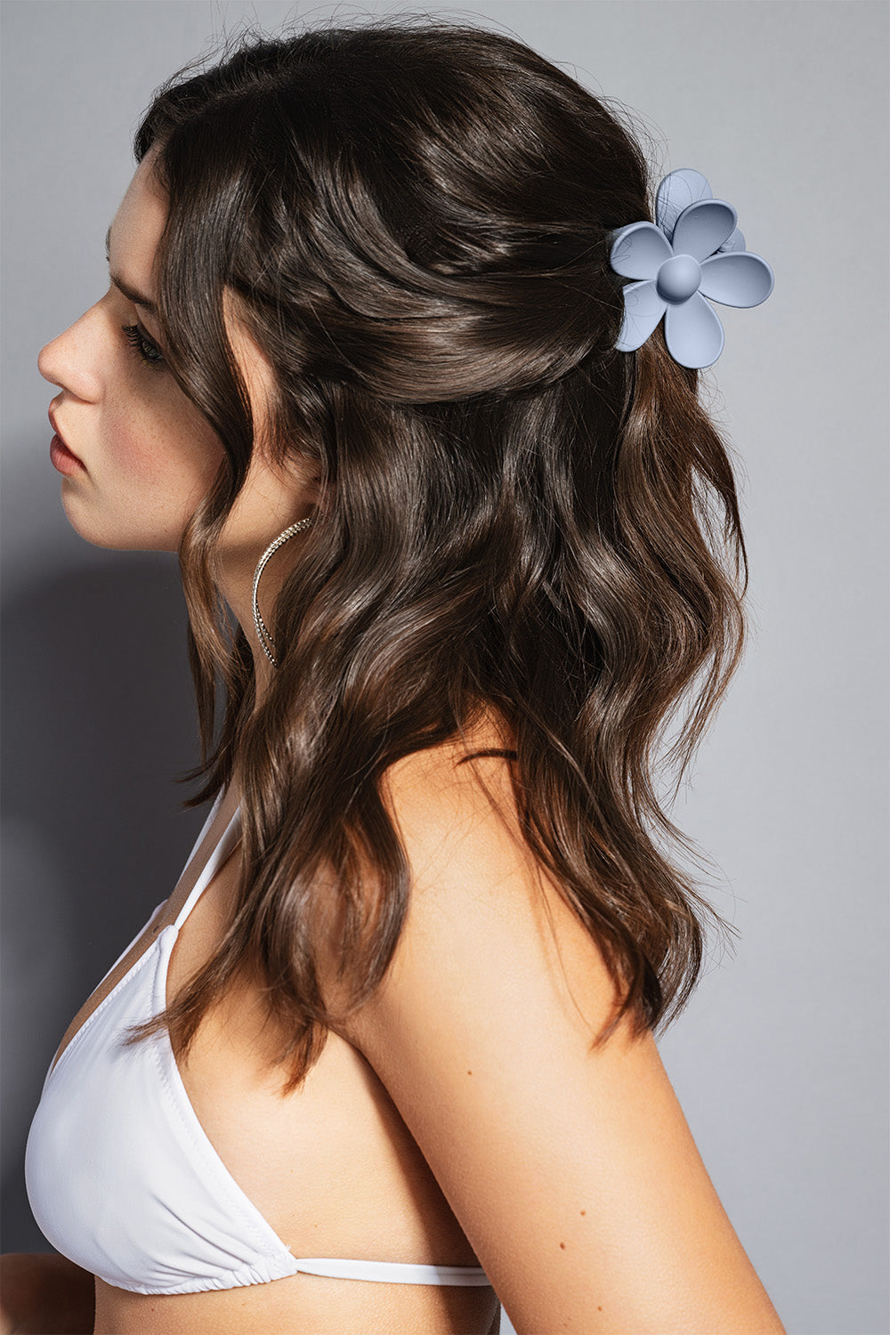 woman wearing flower claw clip in slate blue in hair